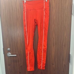 Women’s Fabletics Red Orange Leggings with White Stripes. Size Small